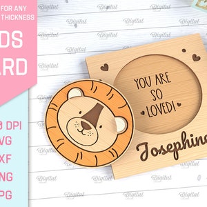 May include: A wooden card with a lion face and the text "You are so loved! Josephine" in a circle. The card is designed for laser cutting.
