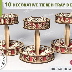 Pode incluir: Três suportes para cupcakes de três níveis com designs intrincados de corte a laser. Cada suporte tem uma base redonda e dois níveis com uma borda decorativa. Os suportes são de madeira e têm uma espessura de 3 mm. Os suportes estão vazios e prontos para serem decorados com cupcakes ou outras guloseimas.