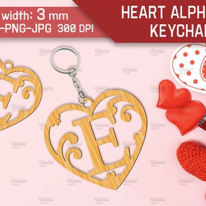 May include: A wooden heart-shaped keychain with a decorative letter E cut out. The keychain is 3 mm thick and comes in SVG, DXF, PNG, and JPG formats at 300 DPI. The image also shows a red and white polka dot heart with the word "love" on it, and several red hearts.