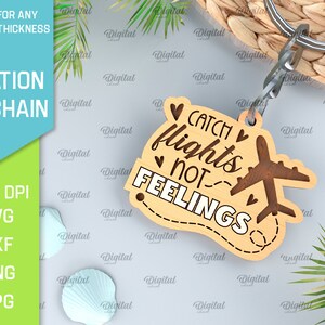 May include: Wooden keychain with the text "Catch flights not feelings" and a small airplane design. The keychain is brown with white text and is attached to a silver key ring.