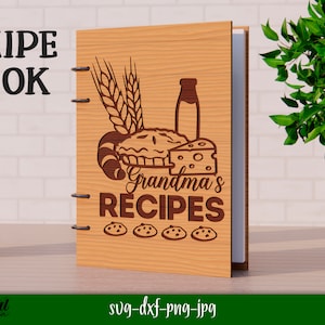 Może przedstawiać: Drewniana książka kucharska z tekstem "RECIPE BOOK" i "Grandma's RECIPES" na okładce. Okładka zawiera r&oacute;wnież ciasto, butelkę mleka, chleb, ser i kłosy pszenicy.