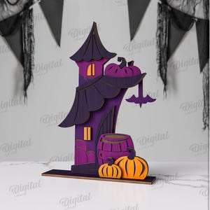 May include: A wooden Halloween decoration in purple and orange, featuring a haunted house design with a bat, pumpkins, and a barrel. The material width is 3 mm. Available in DXF, EPS, PNG, PDF, JPG, and SVG formats.