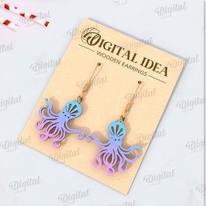 May include: A digital download of a pair of wooden earrings featuring an octopus design. The earrings are a gradient of blue and pink. The text "DIGITAL IDEA WOODEN EARRINGS" is on the card.