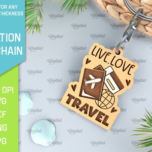 May include: A wooden keychain with the text "Live. Love. Travel" and a design of a passport, airplane, and globe. The keychain is attached to a silver key ring.