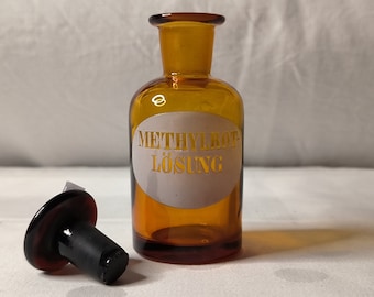 Bottiglia da farmacia "Methyrot Solution" del 1900 con coperchio in vetro smaltato