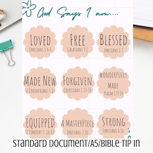 May include: A printable document with the words "Bible Printables" and "God Says I am..." in a handwritten style. The document features nine floral-shaped labels with words like "Loved," "Free," and "Blessed," each with a corresponding Bible verse.