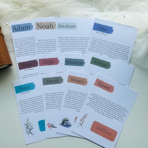 May include: A collection of white cards with names like Adam, Noah, and Abraham, each with a colored banner and text. A brown leather journal is visible on the left. The cards have illustrations of plants and birds.