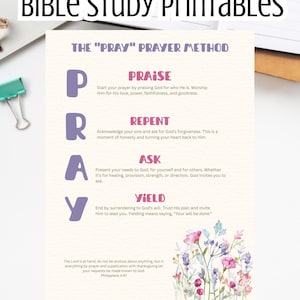 May include: A printable Bible study guide with the text "Bible Study Printables" at the top. The guide outlines the "PRAY" prayer method: Praise, Repent, Ask, and Yield. Floral illustrations and the text "PDF-2 SIZES" are also included.