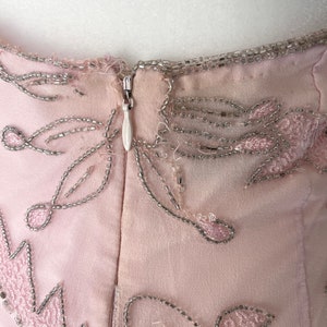 May include: A pink dress with silver beading and a zipper in the back.