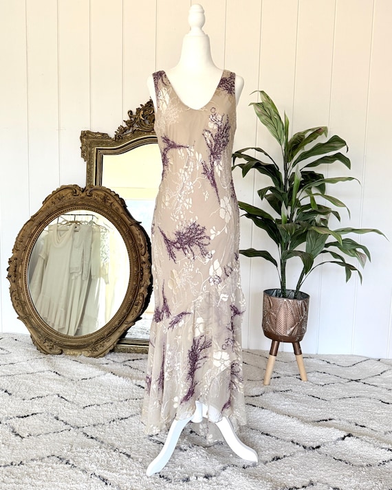 bias cut silk sequin dress SS'26 Bias-cut slip dress in ivory sequins with a draped cowl neckline and fine straps. Tailored darts sculpt and define the body, while the liquid sequin surface catches the light, shaping a