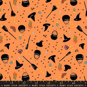 May include: Orange fabric with a Halloween-themed pattern. The design includes black witch hats, brooms, cauldrons, mushrooms, skulls, and stars. The text at the bottom reads "RUBY STAR SOCIETY".