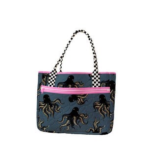 May include: A quilted tote bag in a dark blue-gray color featuring a repeating black and gold octopus pattern. The bag includes a front zippered pocket with bright pink trim and two shoulder straps with a black and white checkered pattern.