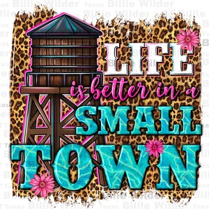 May include: A graphic design featuring a water tower illustration with the text "LIFE is better in a SMALL TOWN." The design incorporates a leopard print background, pink flowers, and a turquoise and brown color scheme.