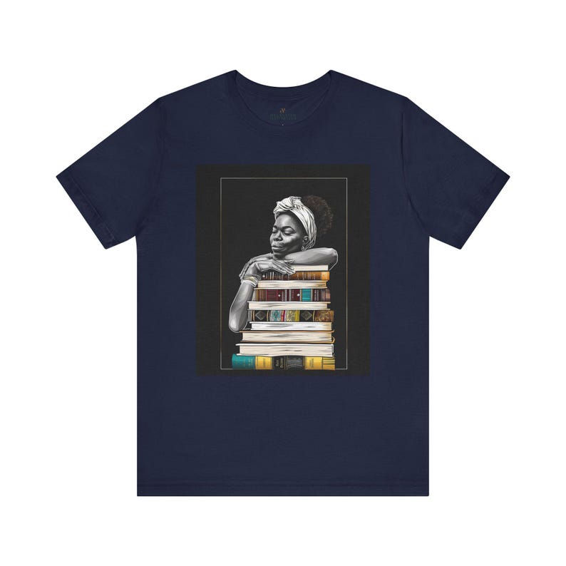 Afrocentric graphic tee shirt featuring a peaceful Black woman embracing a stack of books, symbolizing education, knowledge, freedom, and generational legacy.