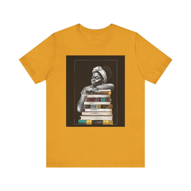 Afrocentric graphic tee shirt featuring a peaceful Black woman embracing a stack of books, symbolizing education, knowledge, freedom, and generational legacy.