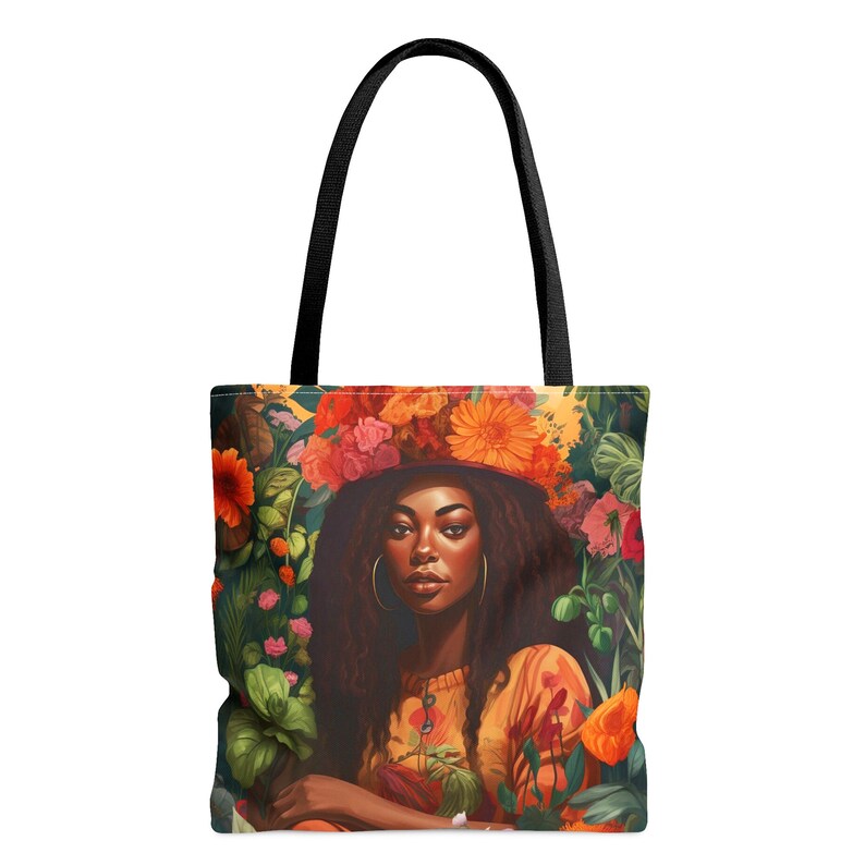 Black Girl in the Garden Tote Bag featuring an Afrocentric lady surrounded by vibrant wildflowers. A stylish and durable tote perfect for garden lovers, plant enthusiasts, and everyday essentials.