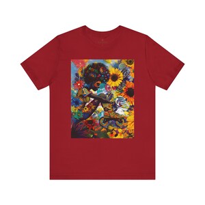 Black Woman Roller Skater Tee featuring a retro-style design with a big Afro, skating through a field of psychedelic colorful wildflowers. A bold Afrocentric tee perfect for roller derby teams and vintage fashion lovers.
