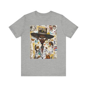 Black Cowboy Tee featuring a cartoon-style African American cowboy smoking a cigarette and drinking whiskey. A bold, graffiti collage pop art design with an edgy Western and Afrocentric cultural vibe.