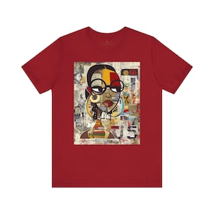 Boss Babe graphic tee featuring an abstract cartoon-style Black woman with large round black eyeglasses. The design has a vibrant, graffiti-inspired aesthetic that celebrates African American beauty, confidence, and urban art style.