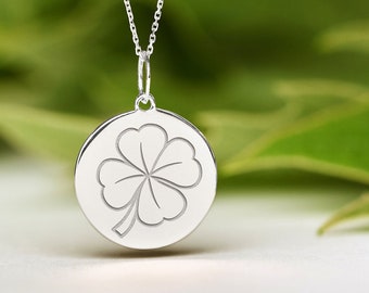 May include: A silver necklace with a round pendant featuring a four-leaf clover design.