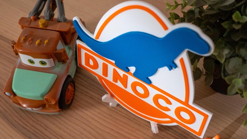 Drukowane w 3D logo Dinoco | Dekoracja do pokoju wyścigowego dla dzieci | Tabliczka z motywem Pixar Cars | Sztuka w przedszkolu Chłodnica Górska | Prezent urodzinowy dla chłopców zdjęcie 3