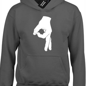May include: Charcoal grey hoodie featuring a white hand gesture, forming an 'okay' sign. The hoodie includes a front pocket and a hood with a drawstring. A black tag with "Garment Printing" is attached.