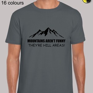 May include: A dark gray t-shirt with a black mountain graphic and the text "MOUNTAINS AREN'T FUNNY THEY'RE HILL AREAS!"