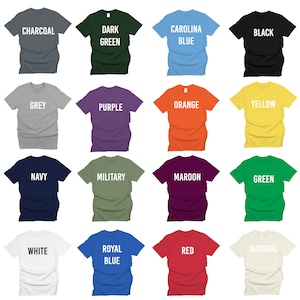 May include: A color chart showing 16 different t-shirt colors. The colors are: Charcoal, Dark Green, Carolina Blue, Black, Grey, Purple, Orange, Yellow, Navy, Military, Maroon, Green, White, Royal Blue, Red, and Natural.