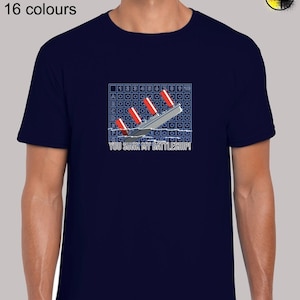 May include: A navy blue t-shirt with a graphic of a sinking battleship on a game board. The text "YOU SUNK MY BATTLESHIP!" is printed below the graphic.