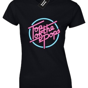 May include: Black t-shirt featuring a pink and blue neon sign graphic that reads "Top of the Pops".