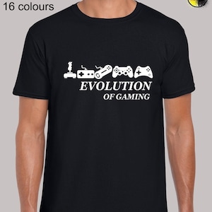 May include: Black t-shirt featuring a white graphic of the evolution of gaming controllers. The graphic includes a joystick, NES controller, Super Nintendo controller, Playstation controller, and Xbox controller. The text "Evolution of Gaming" is below the controllers.