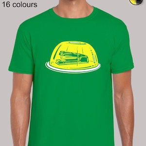 May include: A green t-shirt featuring a yellow graphic of a stapler inside a bowl of yellow jelly. The text "Sizes: S - 5XL 16 colours" is at the top of the image.