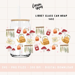 May include: A clear Libbey glass can wrap with a bamboo lid and straw. The wrap features illustrations of teapots, mushrooms, tea bags, and jars of jam. The text "LIBBEY GLASS CAN WRAP 16OZ" is displayed.