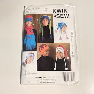 May include: A Kwik Sew pattern packet, number 3354, featuring various hat designs for adults and children. The packet shows images of the finished hats, including a snowman hat, elf hats, and a floral hat. Sizes XS-S-M-L-XL.