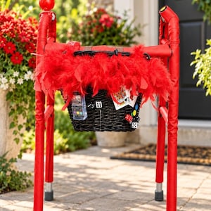 May include: A red mobility walker featuring a black wicker basket adorned with a vibrant red feather boa. The basket is decorated with playing cards, dice, and a small slot machine toy. The walker frame is wrapped in red fabric with a red ball topper.