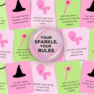 May include: Pink and green cards with inspirational quotes about confidence, believing in yourself, and defying gravity. The cards feature illustrations of stars, wands, and witches' hats. The text on the cards reads "Your Sparkle, Your Rules".
