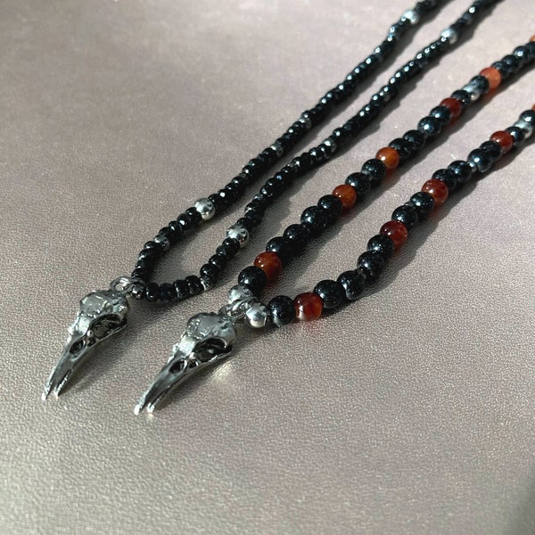 Long necklace with small raven skull