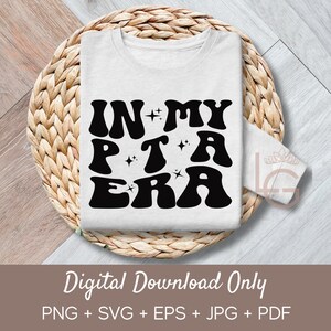 May include: A white t-shirt with black text that reads "IN MY PTA ERA" in a retro font with stars. The text is centered on the shirt.