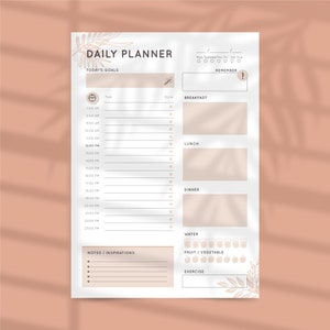 Puede incluir: Un planificador diario imprimible con un diseño floral. El planificador incluye secciones para las metas del día, las tareas, las notas y las inspiraciones. También tiene secciones para las comidas, la ingesta de agua, el consumo de frutas y verduras y el ejercicio.