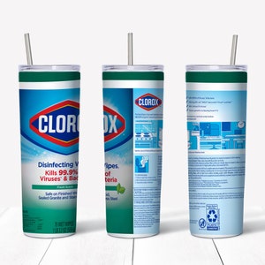 May include: A stainless steel tumbler with a green lid and a straw. The tumbler is wrapped with a Clorox Disinfecting Wipes label. The label features the Clorox logo, product information, and a green leaf design. The tumbler is on a white wooden surface.