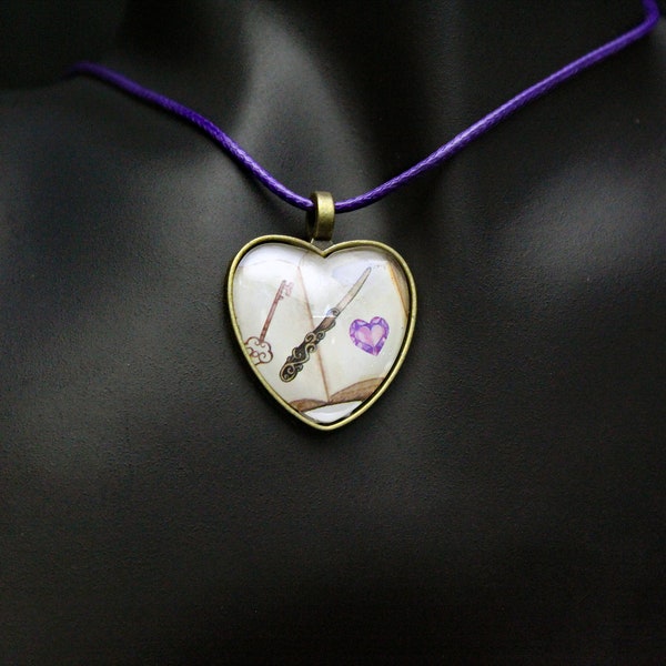 Open Book with a Key, a Letter Opener, and a Glass Purple Heart on a Heart Shaped Cabochon Pendant on an 18" Purple Cord