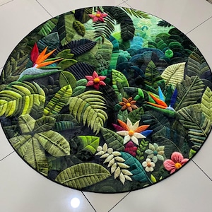 May include: Circular rug depicting a detailed jungle scene with green foliage, colourful flowers, and birds of paradise. The rug has a black border and a textured design, creating a three-dimensional effect.