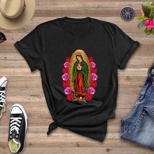 May include: Black t-shirt with a graphic print of the Virgin Mary surrounded by pink and red roses.
