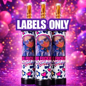 May include: Three cylindrical beverage containers with a woman's face, sunglasses, and blue hair. The containers have a white background with a pattern of hearts, leopard spots, and the text "BIG FUCKING AQUARIUS". The top of each container has a gold-colored cap, and the text "LABELS ONLY" is displayed.