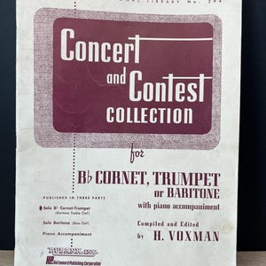 May include: A vintage music book cover with the title "Concert and Contest Collection" in white text on a maroon background. The book is for Bb cornet, trumpet, or baritone, with piano accompaniment. Published by Rubank, Inc.