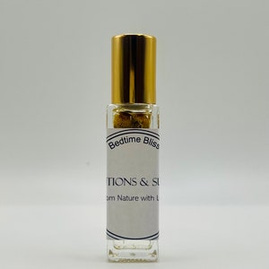 May include: A clear glass roll-on bottle with a gold cap and a white label that reads "Bedtime Bliss" and "Infusions & Solutions from Nature with Love".