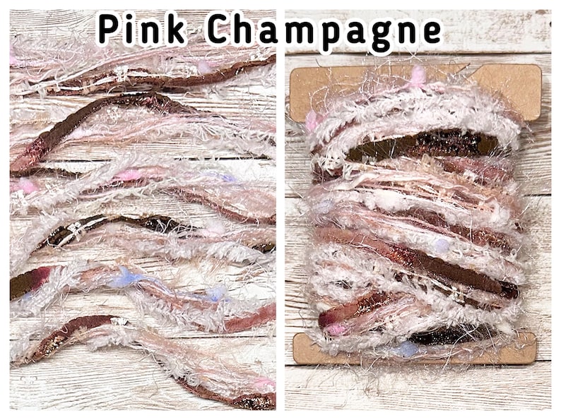 May include: A spool of Pink Champagne yarn featuring a mix of textures, including fuzzy white fibres, metallic copper ribbons, and small pink and light blue accents. The yarn is wrapped around a rectangular cardboard bobbin.