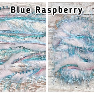 May include: Two images of Blue Raspberry yarn. The yarn is a mix of white, light blue, and pink fibres with a fluffy texture. The text "Blue Raspberry" is displayed in black letters at the top of the image.