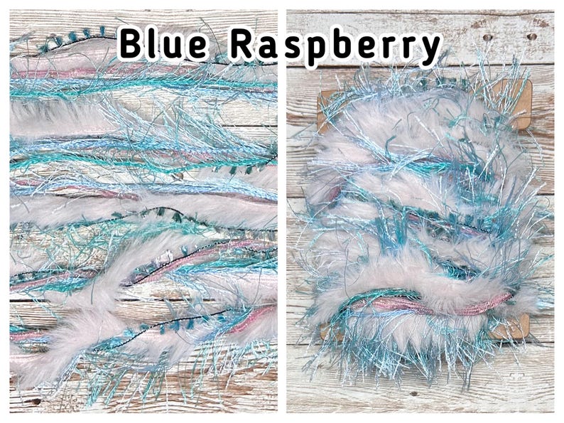 May include: Two images of Blue Raspberry yarn. The yarn is a mix of white, light blue, and pink fibres with a fluffy texture. The text "Blue Raspberry" is displayed in black letters at the top of the image.