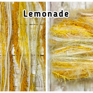May include: A skein of textured art yarn labelled Lemonade, featuring a blend of mustard yellow, bright yellow, and cream-coloured fibres. The yarn consists of various strands, including fuzzy, metallic, and smooth twisted threads.